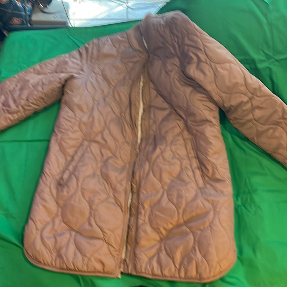 Women’s tan quilted waist length coat with wool lining.